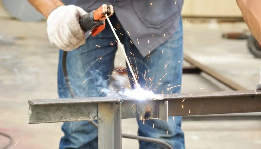 Why do welding rods sticks to the base metal?