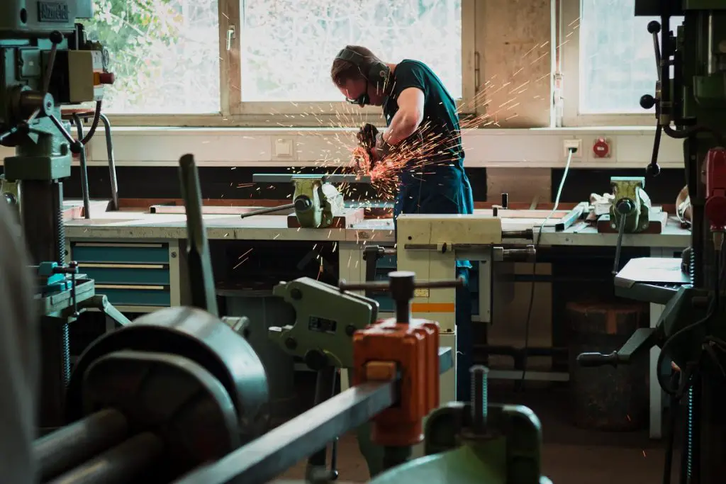 welder using an angle grinder