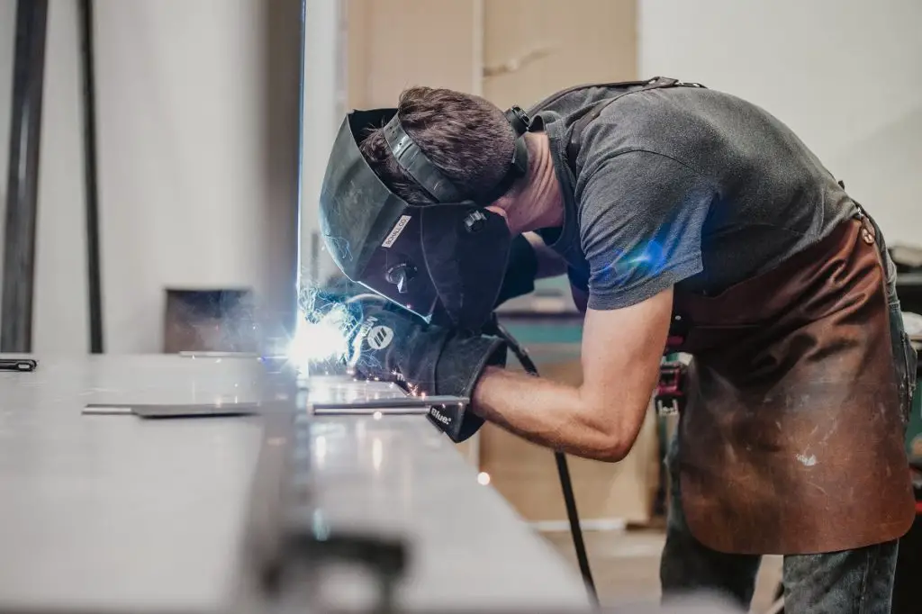 Welder wearing a leather welding apron